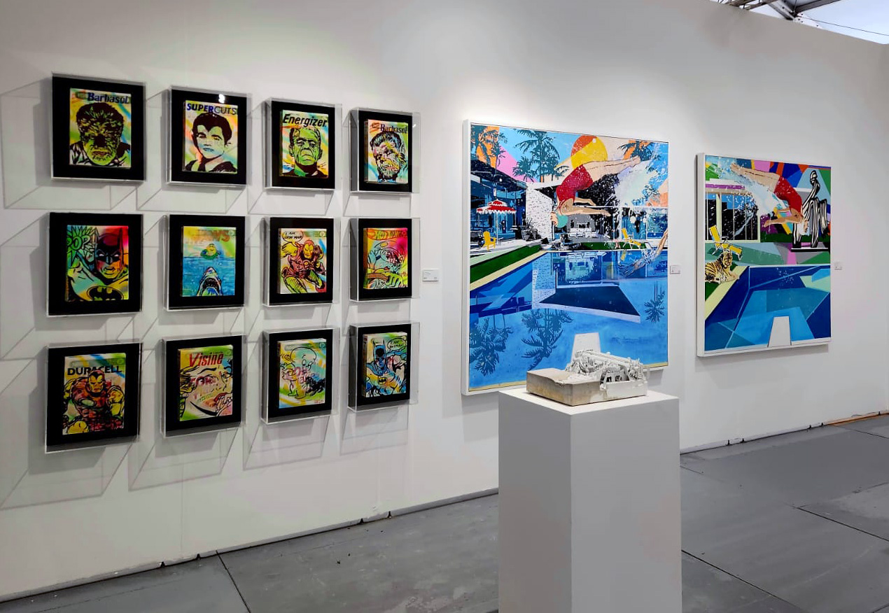 Artist Leonardo Hidalgo and tennis player Vasek Pospisil point to each other in mutual praise as they unveil a mural of famous figures from science, arts and technology gathered around a large table.